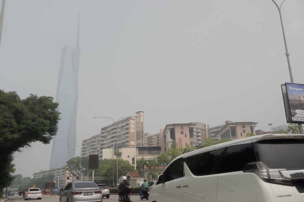 Thick haze partially obscures the Merdeka Maybank Tower as motorists make their way through Kuala Lumpur on October 16, 2026. — Picture by Raymond Manuel
