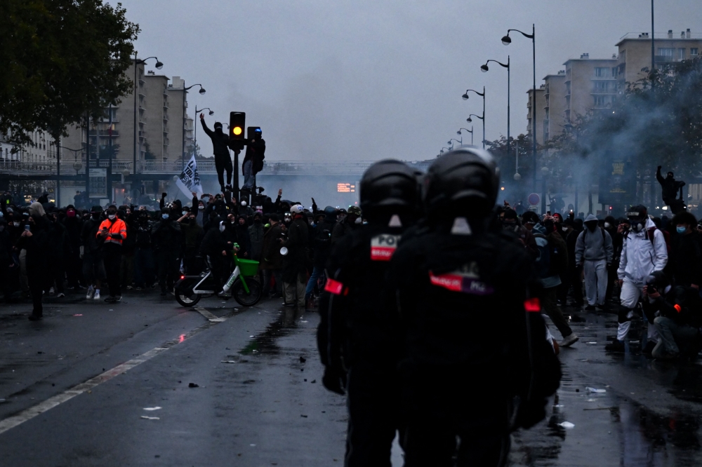 Protesters face BRAV brigade police officers near Porte de Vincennes during a demonstration calling for increased purchasing power, the protection of public services, and fiscal and social justice in Paris on October 24, 2026. — AFP pic