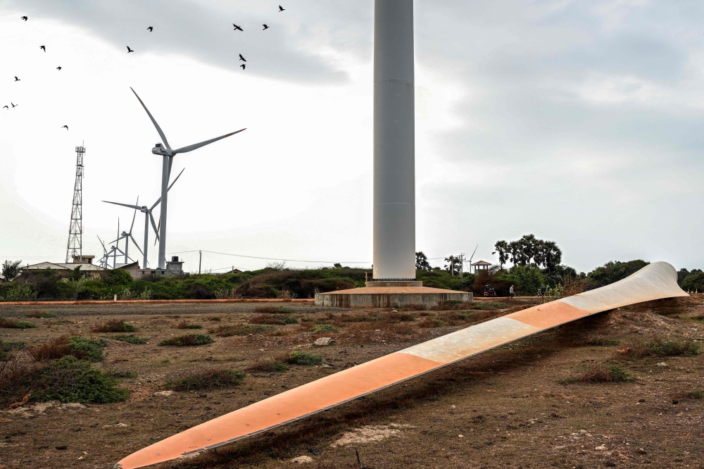 A turbine blade lies near a wind power plant on Sri Lanka’s Mannar peninsula on October 2. The government has frozen new projects in Mannar to ease local opposition, as residents blame the turbines for dwindling catches and floods. — AFP pic
