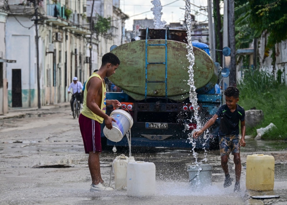 Residents collect potable water from a public supply point in Havana October 5, 2026. Water scarcity adds to Cuba’s runaway inflation, while food and medicine also run low amid mounting social unrest. — AFP pic