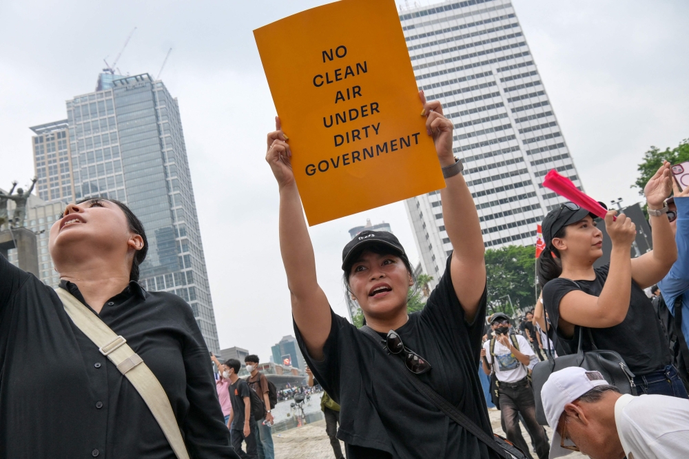 A woman holds a placard reading ‘No Clean Air Under Dirty Government’ as demonstrators gather during a protest against economic hardship, graft and the government’s handling of devastating wildfires causing toxic haze that has sickened thousands in Jakarta October 28, 2026. — AFP pic