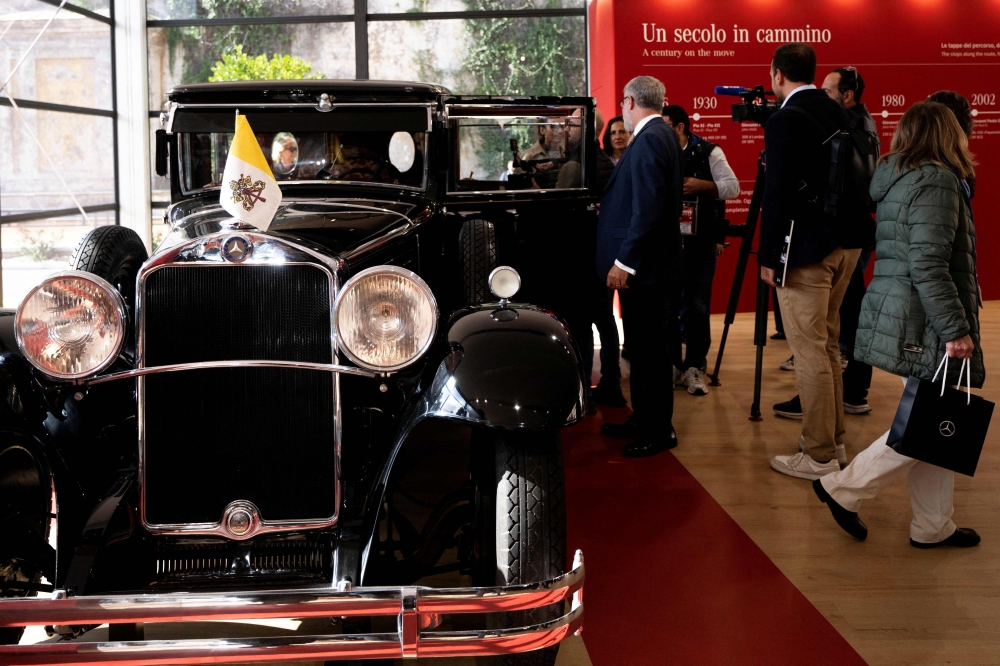 Visitors look at one of the historic papal vehicles on display at the Square Garden (Giardino Quadrato) during the press preview of the ‘A Century of Papamobile’ exhibition, in the Vatican Museums, in Vatican City October 28, 2026. — AFP pic