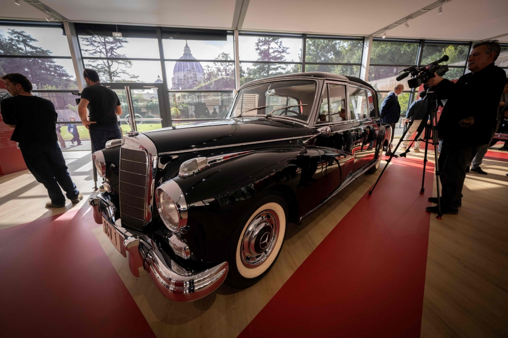 Historic papal cars, including models with luxurious upholstery and protective glass enclosures, are on display in a new exhibition celebrating the Vatican’s motoring heritage. — AFP pic