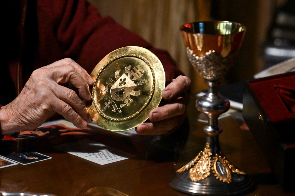 Argentine silversmith Juan Carlos Pallarols displays a paten and a chalice he crafted at his workshop in Buenos Aires on October 20, 2026, ahead of their presentation to Pope Leo XIV during his visit to Argentina. — AFP pic