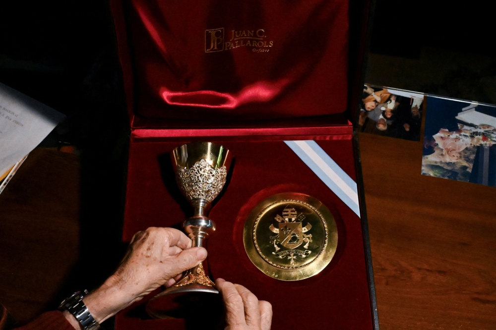 Argentine silversmith Juan Carlos Pallarols displays a paten and a chalice he crafted at his workshop in Buenos Aires on October 20, 2026, ahead of their presentation to Pope Leo XIV during his visit to Argentina. — AFP pic