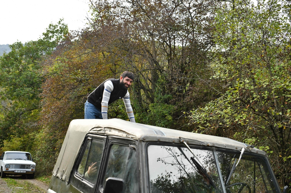 Muraz Arzumanyan rides on a car in the vicinity of the village of Srashen in Armenia’s Shikahogh nature reserve October 22, 2026. — AFP pic