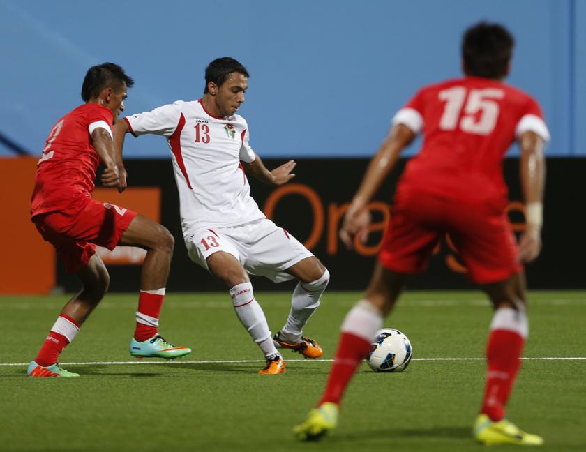 Singapore's Muhammad Shakir Bin Hamzah and Ariq (right) challenge Jordan's Saleh Fayiz Saleh Aljawhary during their Asian Football Confederation (AFC) Asian Cup qualifier football match in Singapore February 4, 2014. u00e2u20acu201d Reuters pic
