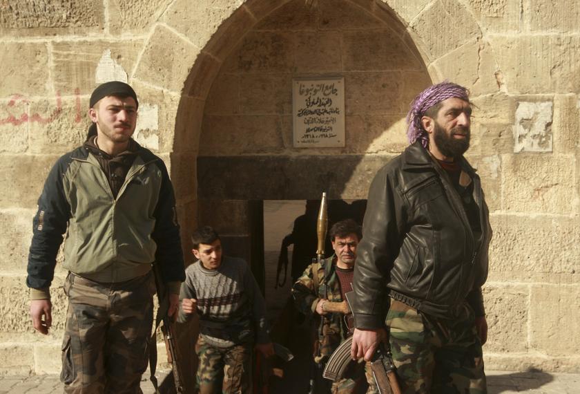 Free Syrian Army (FSA) fighters carry their weapons as they move towards their positions during what the FSA said was an offensive against them by forces loyal to Syria's President Bashar al-Assad near the Justice Palace and the Citadel of Aleppo February