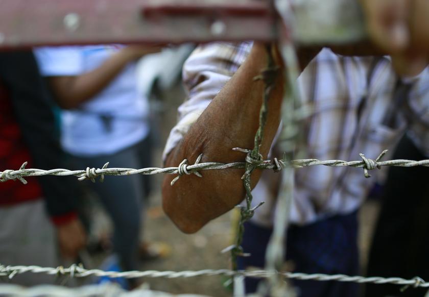 A man stand near prison gate as he waits for his family member in front of Insein prison in Yangon January 3, 2014.  u00e2u20acu201d Reuters pic