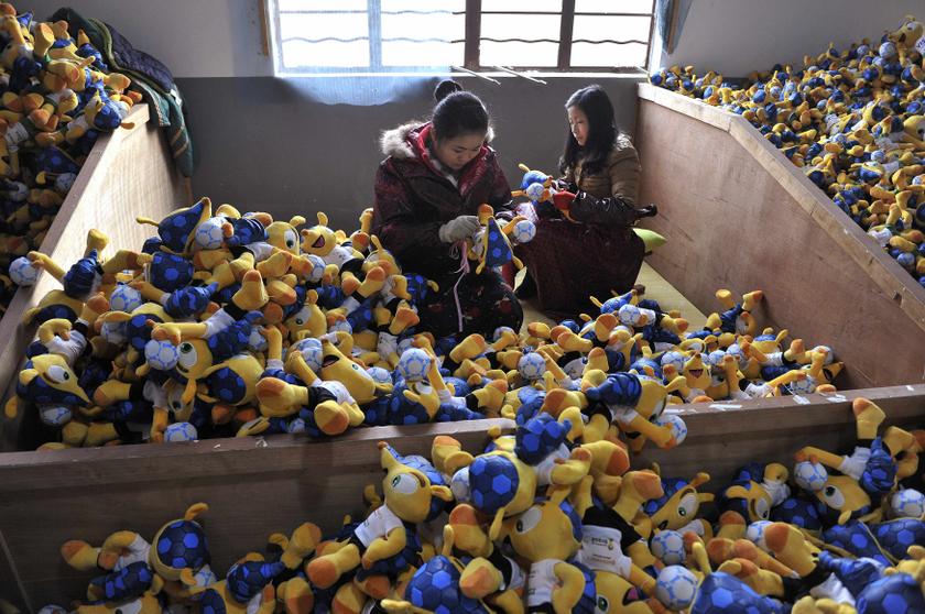 Employees make stuffed toys of Fuleco the Armadillo, the official mascot of the FIFA 2014 World Cup, at a factory in Tianchang, Anhui province January 6, 2014. — Reuters pic