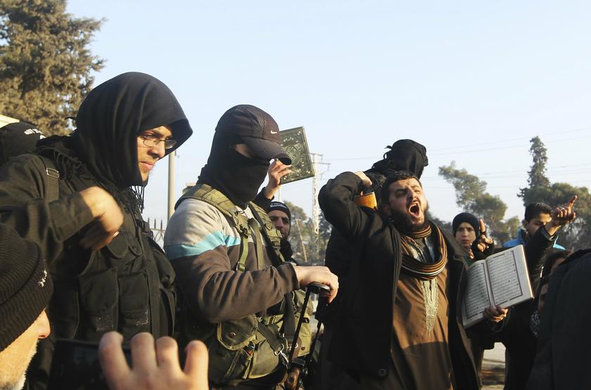 Fighters from the Islamic State in Iraq and the Levant (ISIL) try to calm civilians demonstrating against the rebel infighting in Aleppo January 6, 2014.  u00e2u20acu201d Reuters pic