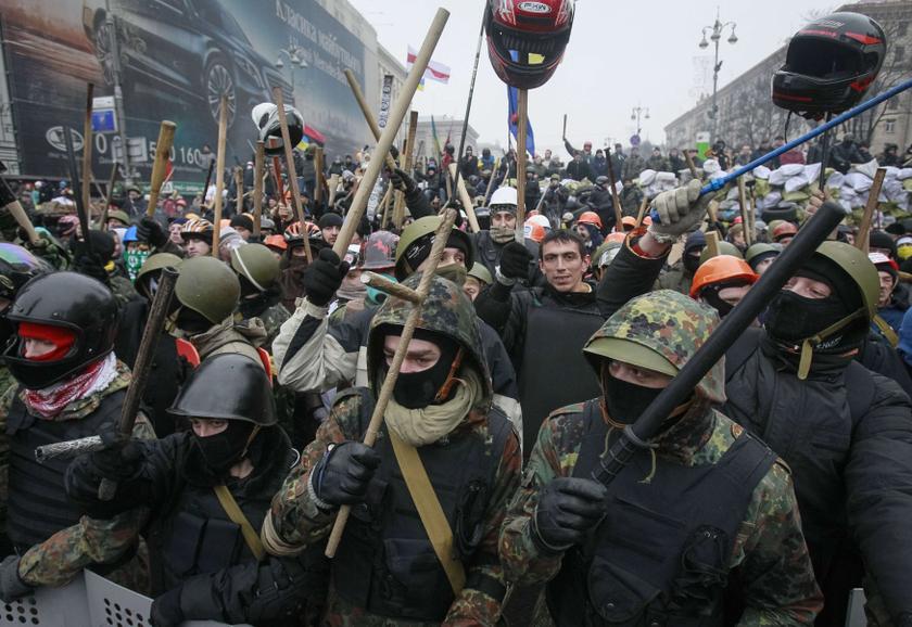 Anti-government protesters react as they stand guard at their barricades in Kiev February 8, 2014. u00e2u20acu201d Reuters pic