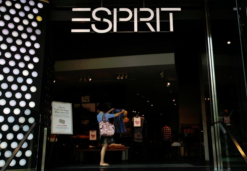 A customer checks a shirt inside the biggest Esprit store at Hong Kong's Tsim Sha Tsui shopping district September 10, 2013. u00e2u20acu201d Reuters pic