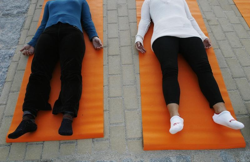 People take part in a free yoga class at the Parque del Oeste in Madrid September 27, 2007. u00e2u20acu201d Reuters pic