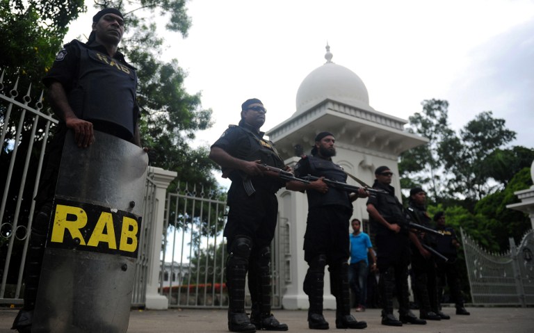 Rapid Action Battalion (RAB) personnel stand guard in front of the high court in Dhaka on August 1, 2013, after a verdict was delivered in which Bangladesh's main Islamist party Jamaat-e-Islami was banned. u00e2u20acu201d Reuters pic