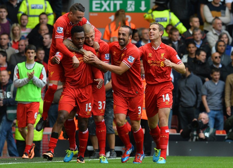 Liverpool's English striker Daniel Sturridge (2nd left) celebrates with teammates after scoring the opening goal of the English Premier League match between Liverpool and Manchester United at the Anfield stadium in Liverpool, September 1, 2013. u00e2u20acu201d AFP pi