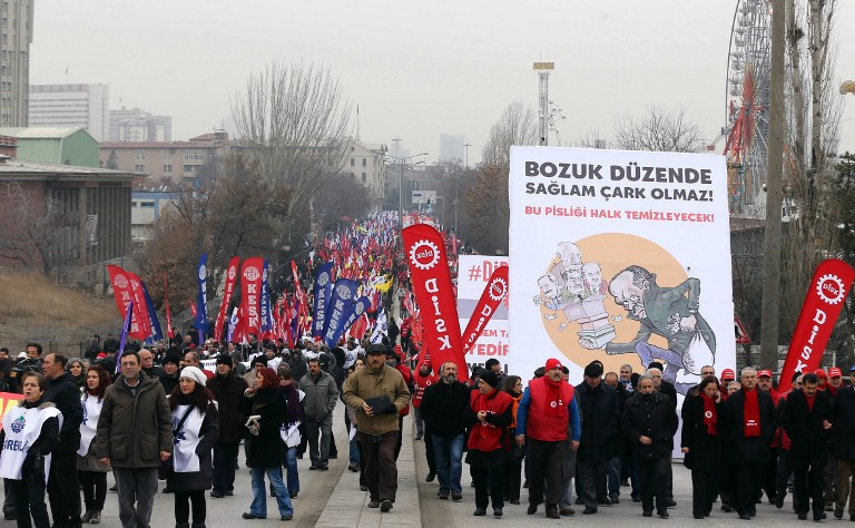 Protesters hold a placard with a cartoon depicting Turkish Prime Minister Recep Tayyip Erdogan and his three cabinet ministers who resigned under a huge graft scandal during an anti-corruption protest in Ankara on January 11, 2014. u00e2u20acu201d AFP pic