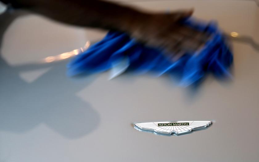 A worker cleans next to an Aston Martin logo on a car inside the company's showroom in Doha, October 19, 2013. u00e2u20acu201d Reuters pic