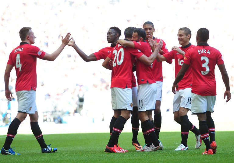 Manchester United's Dutch striker Robin Van Persie (3rd left) celebrates with teammates after scoring their second goal during the FA Community Shield football match against Wigan Athletic at Wembley Stadium in north London on August 11, 2013. u00e2u20acu201d AFP pic