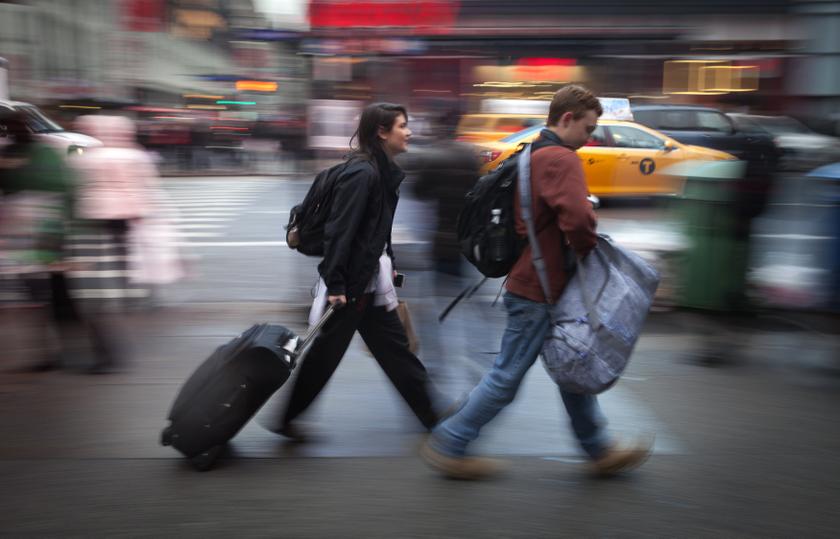 Travelers walk towards Penn Station in the rain in New York, November 27, 2013. The Thanksgiving holiday is one of the busiest travel times in the United States.  u00e2u20acu201d Reuters pic