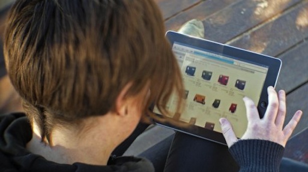 A woman uses an iPad to shop online. u00e2u20acu201d AFP pic