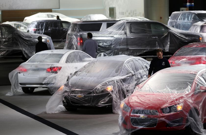Vehicles are covered with protective wrap as workers prepare the General Motors automakers display ahead of the media preview of the North American International Auto Show at Cobo Center in Detroit, Michigan January 12, 2014. u00e2u20acu201d Reuters pic