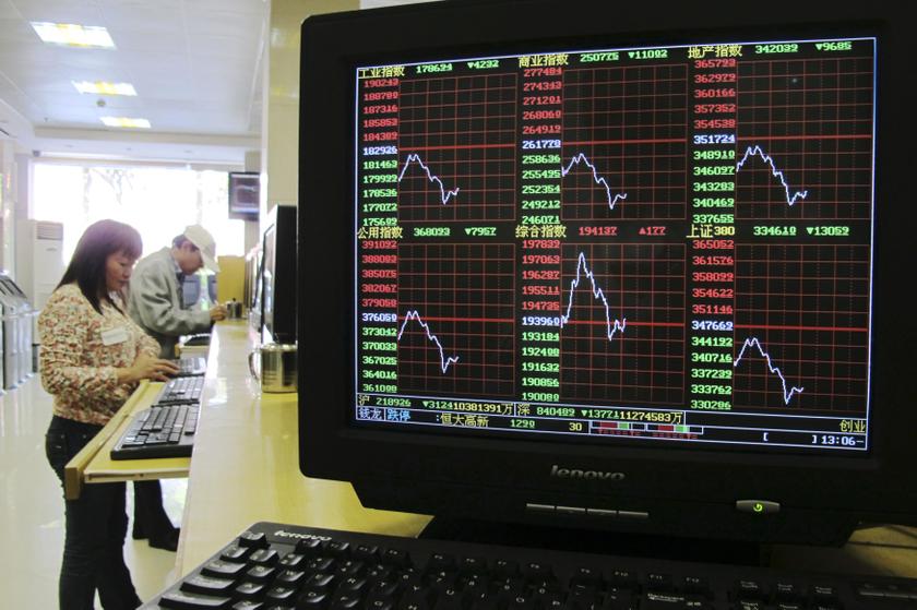 A computer screen showing stock information is seen next to investors at a brokerage house in Haikou, Hainan province, December 2, 2013. u00e2u20acu201d Reuters pic
