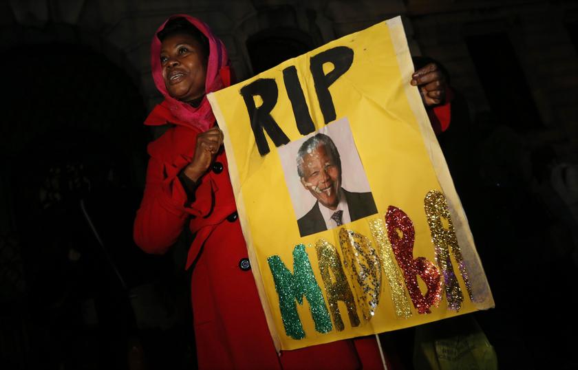 A woman holds a sign at a gathering in memory of Nelson Mandela outside the South African High Commission across from Trafalgar Square in London December 5, 2013. u00e2u20acu201d Reuters pic