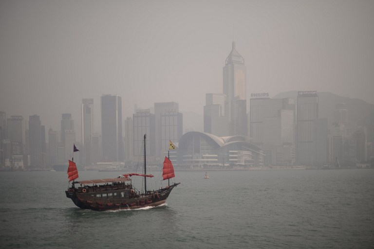 A junk sails past the city's skyline shrouded in a dense blanket of toxic smog in Hong Kong on April 15, 2013. u00e2u20acu201d AFP pic