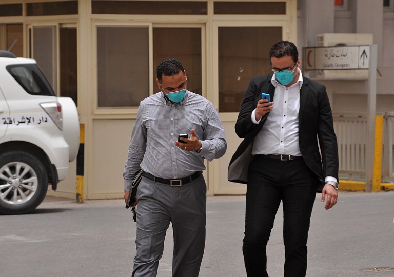 Egyptian medical workers wear masks as they leave the emergency section in King Fahad hospital in the city of Hofuf, 370 kms East of the Saudi capital Riyadh, on June 16, 2013. u00e2u20acu201d AFP pic