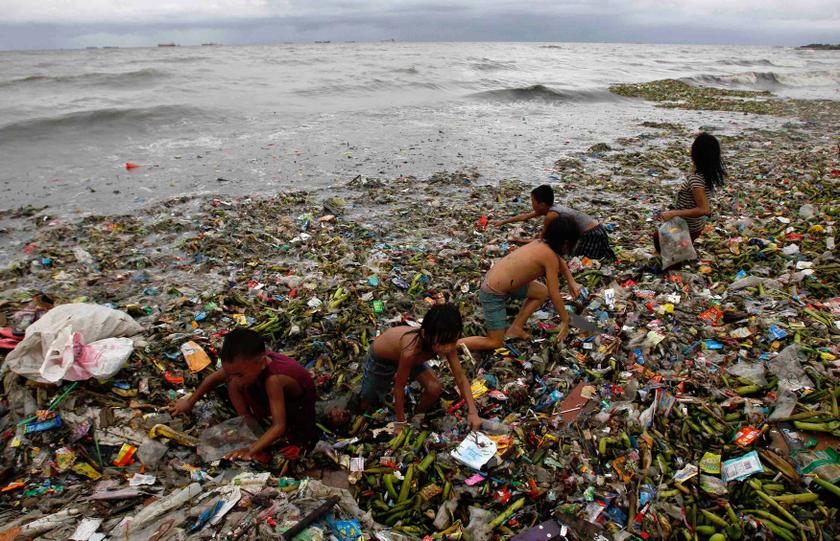 Children sift through floating garbage as they collect recyclable items to sell while strong waves crash along the shores of Manila Bay, near a slum area in Manila August 12, 2013. u00e2u20acu201d Reuters pic