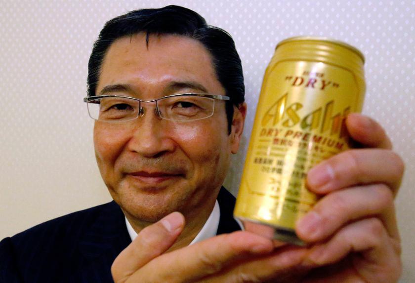 Akiyoshi Koji, president of Asahi Breweries Ltd., poses with its new product Asahi Super Dry Premium during a photo opportunity after its unveiling in Tokyo December 12, 2013. u00e2u20acu201d Reuters pic