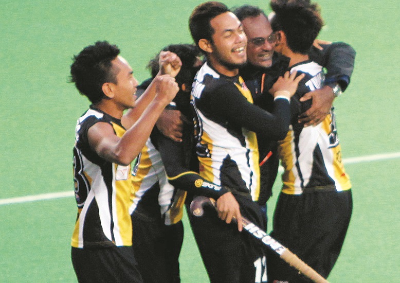 WE MADE IT: Dharmaraj hugging his heroes (from left) Haziq Samsul, Hafiz Zainol (hidden), Syamim Yusof and Zulhairi Hashim (back to camera) after an impressive 2-1 win over South Korea.