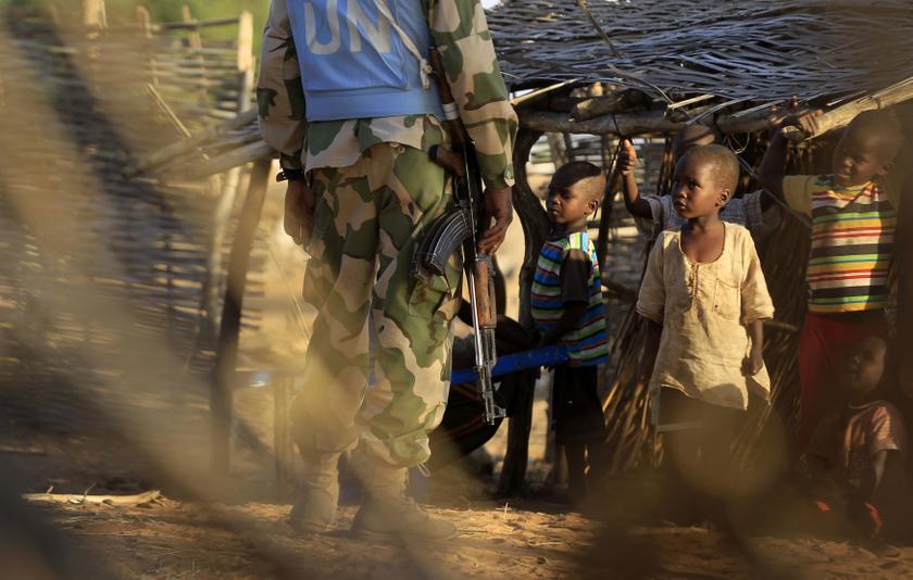 nInternally displaced children look at an African Union - United Nations Hybrid Operation in Darfur (UNAMID) peacekeeper standing guard near the vicinity of a UNAMID base near Labado, South Darfur December 9, 2013. u00e2u20acu201d Reuters pic