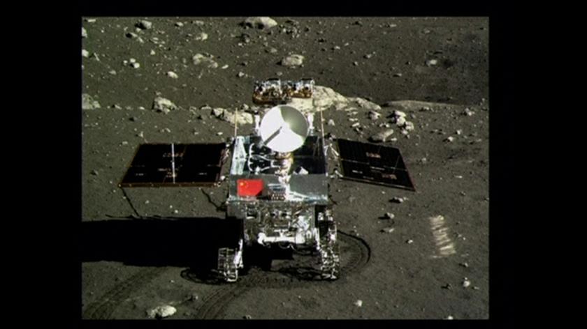 A view of China's first moon rover, Yutu, or Jade Rabbit, is seen on the lunar surface with the Chinese national flag in this still image taken from video provided by China Central Television (CCTV) December 16, 2013.