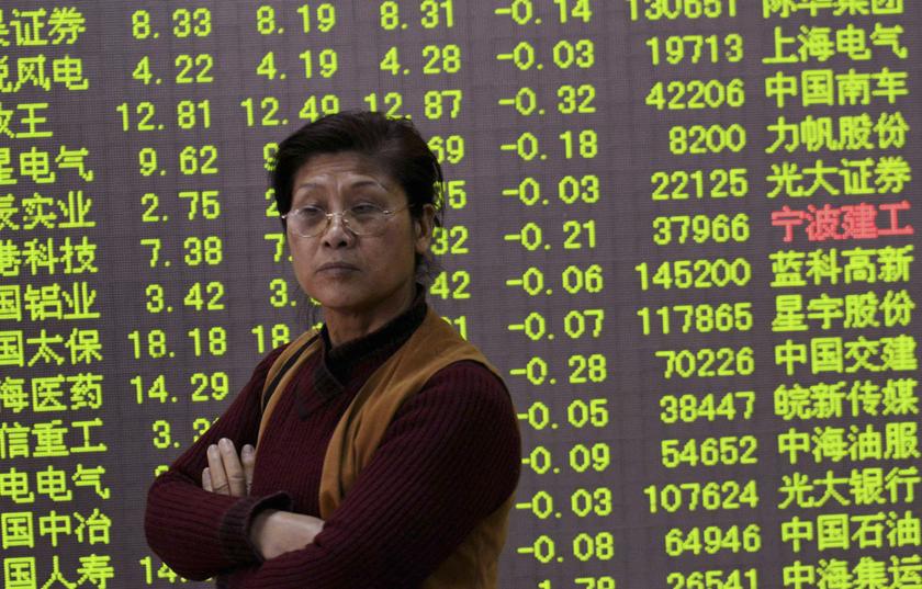 An investor stands in front of an electronic board showing stock information filled with green figures indicating falling prices at a brokerage house in Hangzhou, Zhejiang province December 26, 2013. u00e2u20acu201d Reuters pic