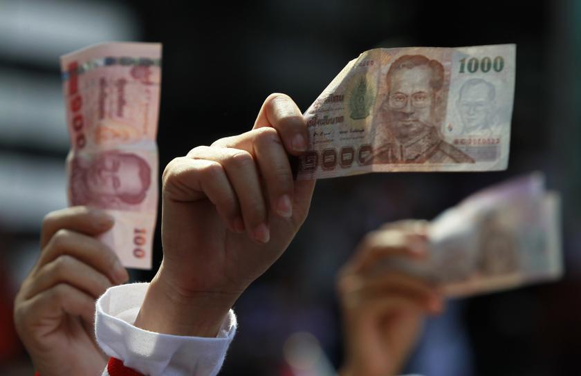 An anti-government protester holds money to donate to protest leader Suthep Thaugsuban as he leads thousands of protesters in a march in central Bangkok January 13, 2014. u00e2u20acu201d Reuters pic