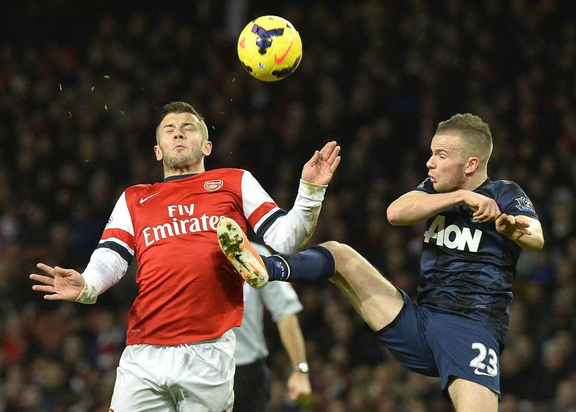Arsenal's Jack Wilshere (left) is challenged by Manchester United's Tom Cleverley during their English Premier League soccer match at the Emirates stadium in London February 12, 2014. u00e2u20acu201d Reuters pic