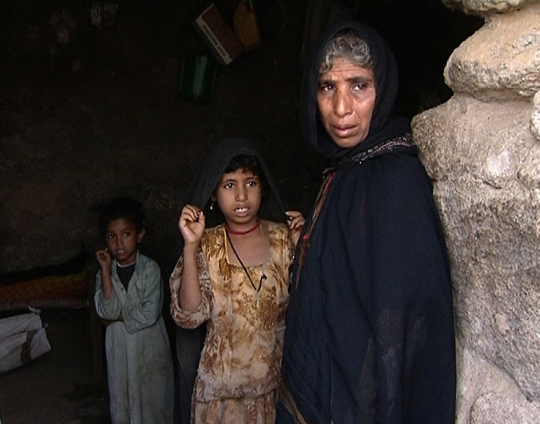 Nejma, mother of Yemeni child bride Ilham al-Ashi who died after being sexually violated by her husband, stands with two of her other children in the village of al-Asha, northwest of the capital Sanaa, on April 11, 2010. u00e2u20acu201d AFP pic