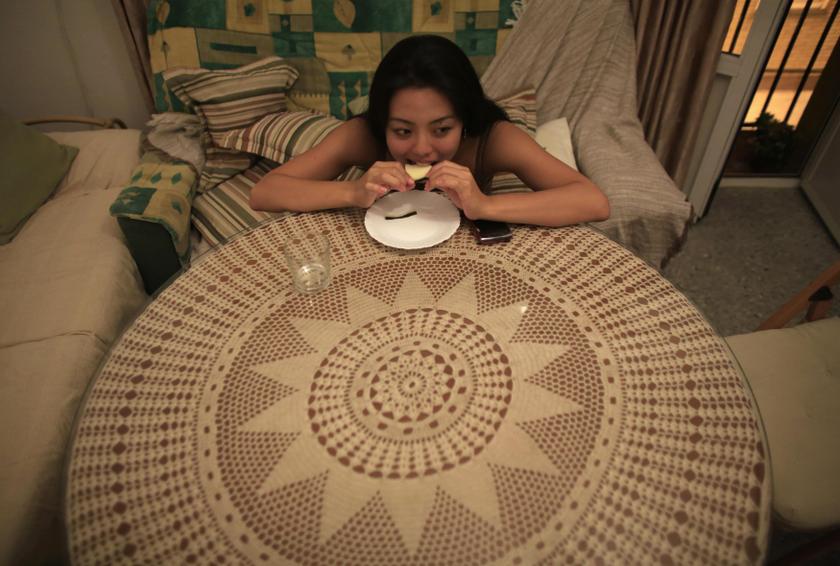 Japanese flamenco student Maika Kubo, 24, eats cheese at her home in the Andalusian capital of Seville, Spain. December 13, 2013. u00e2u20acu2022 Reuters pic