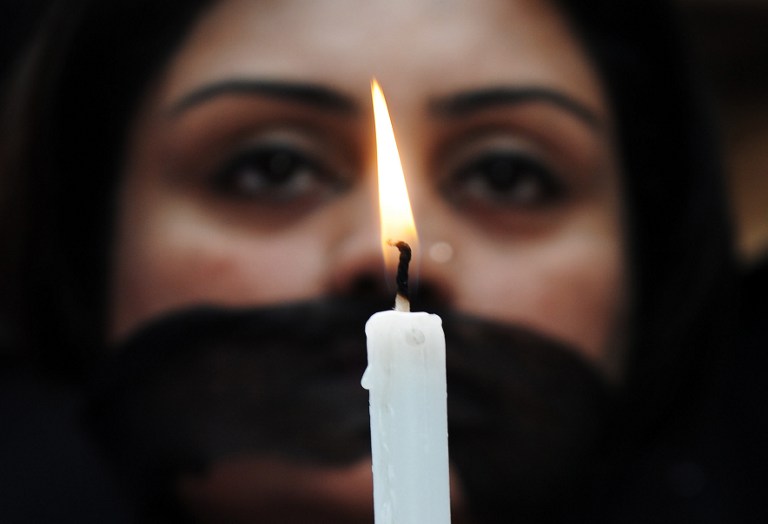 Indian members of a social organisation Our City Our Right holds a candle during a silent protest following the recent gang rape and murder of a 20-year-old college student in Barasat, in Kolkata on June 15, 2013. u00e2u20acu201d AFP pic