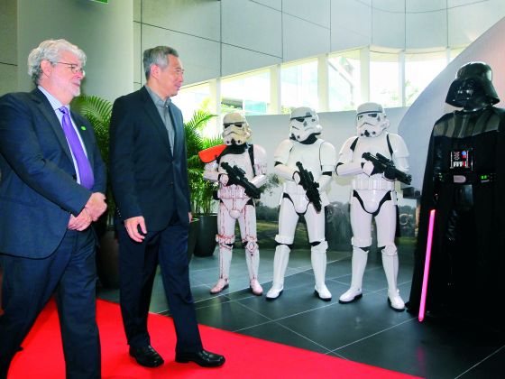 PM Lee Hsien Loong walking the red carpet with George Lucas while costume characters from Star Wars receive them at the official launch of Lucasfilm's building dubbd The Sandcrawler. u00e2u20acu201d Picture by Don Wong/Today