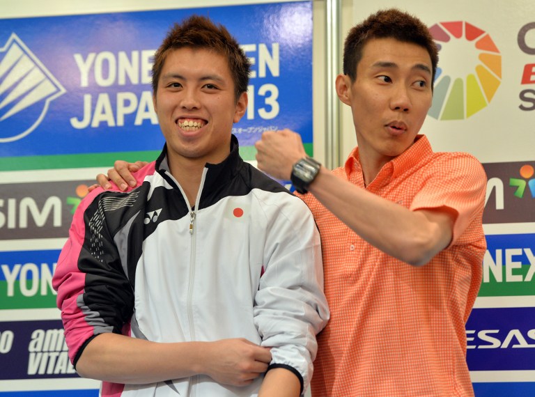 Malaysian badminton star Lee Chong Wei (right) smiles as he stands with Japanese player Kenichi Tago at a press conference in Tokyo on September 17, 2013. u00e2u20acu201d AFP pic
