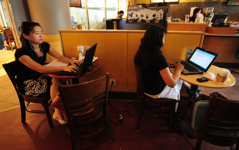 Women use their laptop computers at a wireless cafe in Beijing on July 3, 2009. Chinese billionaires Jack Ma and Zhang Jindong may get licenses this month to start phone companies in China. u00e2u20acu201d AFP pic