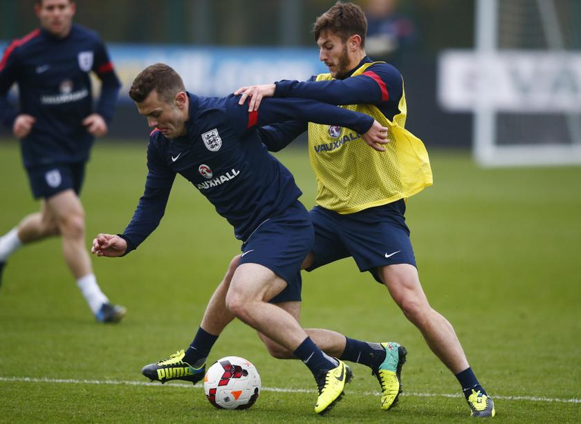 England national football team player Jack Wilshere is tackled by teammate Jay Rodriguez (right) during a team training session at Arsenal's training facility in London Colney, north of London, November 18, 2013. u00e2u20acu201d Reuters pic