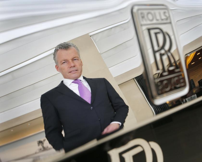Rolls-Royce Motor Cars Chief Executive Officer, Torsten Mueller-Oetvoes, is reflected in the rear of a Rolls-Royce Phantom as he poses for a photograph at a showroom in Singapore October 8, 2013. — Reuters pic