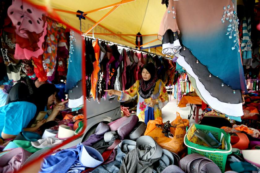 People buy new cloth, scarf, and food for Hari Raya at Pasar Tani Kuala Besut, July 16, 2013. u00e2u20acu201d Picture by Saw Siow Feng