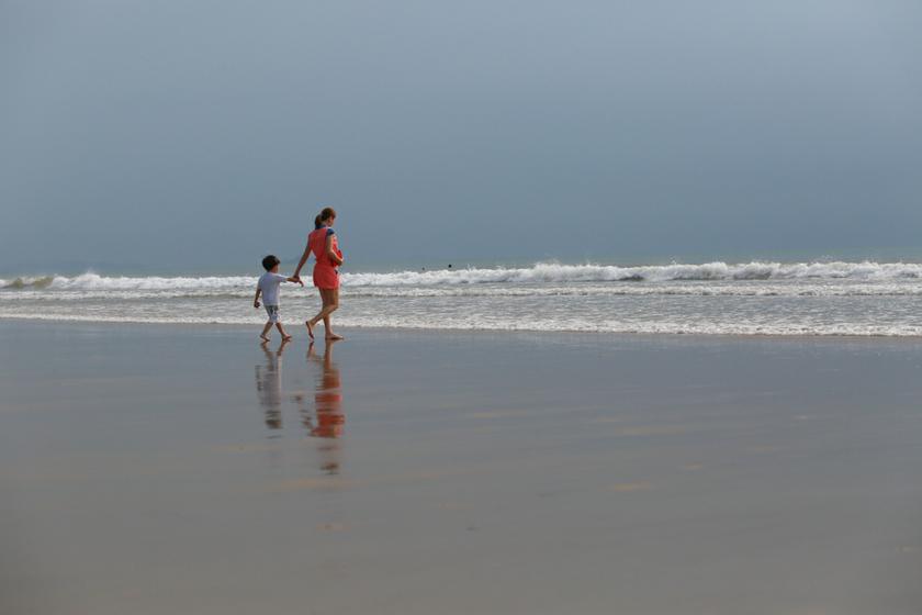 A mother and her child take a leisurely walk along the popular Tanjung Aru beach in Kota Kinabalu, Sabah, which is known for its eco-tourism and natural attractions. The state government is currently investing heavily in developing downstream industries in the fields of oil and gas and palm oil.