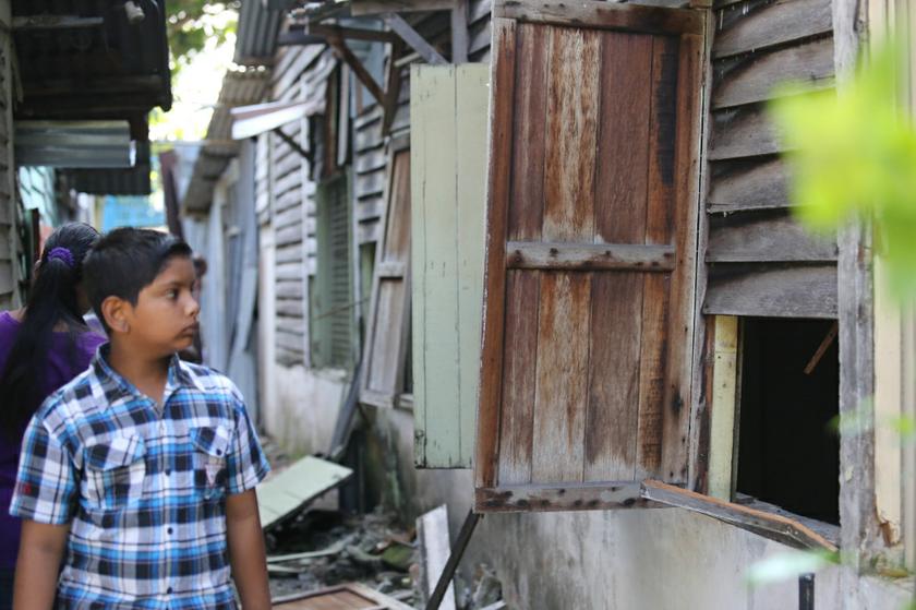 A boy looks into his former home as workers went about with the scheduled demolition of houses in Kg Railway in Sentul.