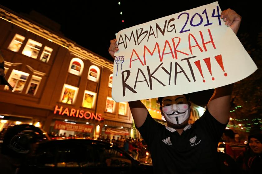 A man holds a banner during the u00e2u20acu02dcTurunu00e2u20acu2122 anti-price hike rally in Kuala Lumpur December 31, 2013. u00e2u20acu201d Picture by Saw Siow Feng